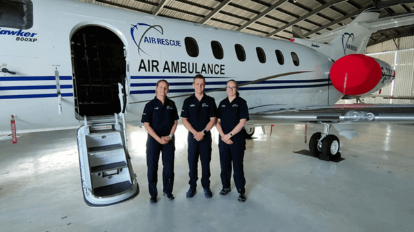 Air rescue group team in front of plane