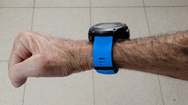 Person showing off wrist locator device
