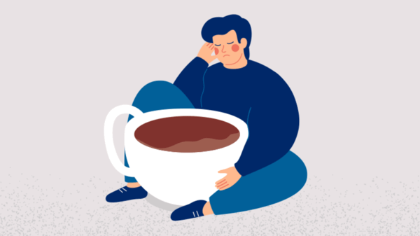Tired man with huge cup of coffee