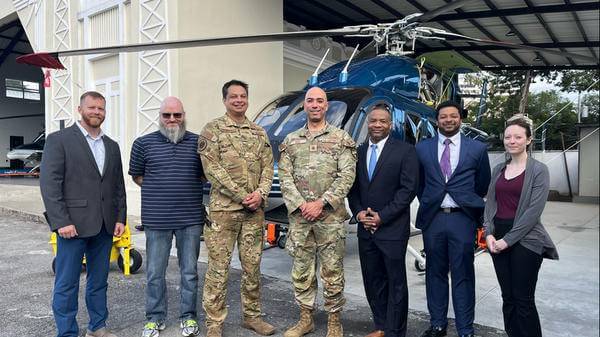 US and Guatemalan military representatives in front of Bell 429 helicopter