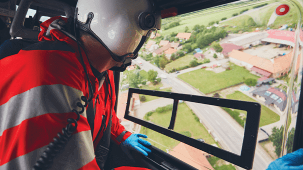 Paramedic looking out of helicopter