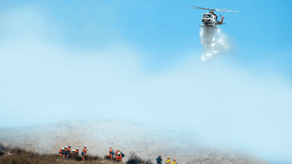 Helicopter flying over hill