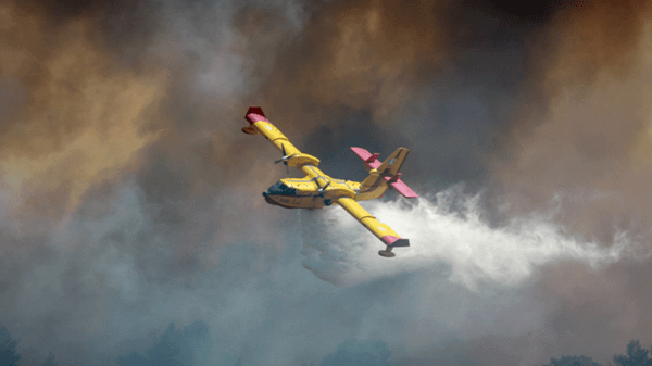 Yellow plane putting out forest fire
