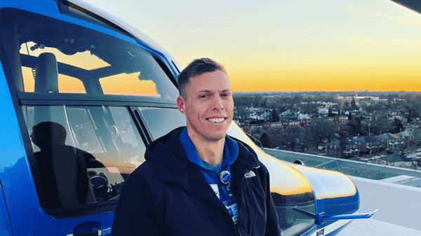 Matt Baily next to helicopter