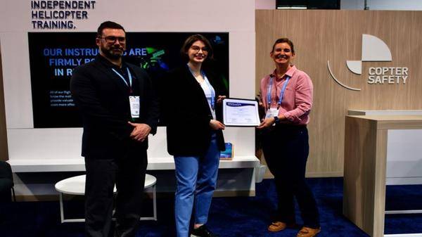 Image of Copter Safety ccepting Whirly-Girls Certificate of Appreciation from Bridget Colby of Whirly-Girls International at Heli-Expo 2024