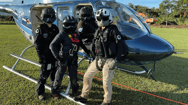Crew sitting by helicopter