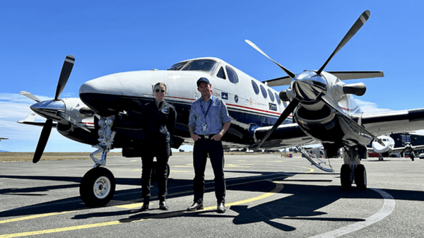 Crew standing in front of plane
