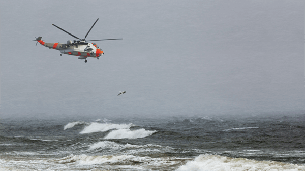 Rescue helicopter flying above sea