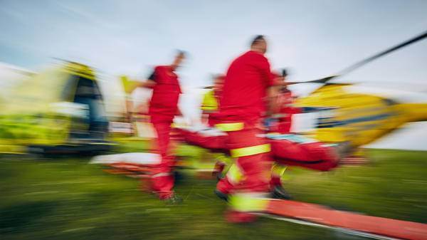 Medieval crew putting passenger in helicopter