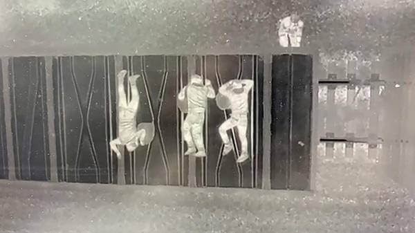 Infrared image of people hiding