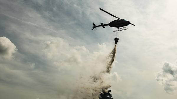 Helicopter putting out forest fire