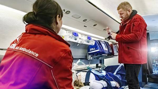 Paramedics helping patient