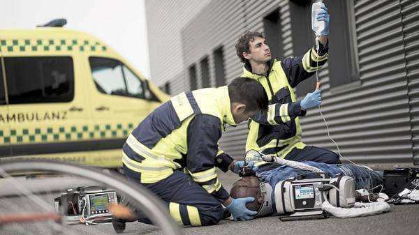 Paramedics helping patient