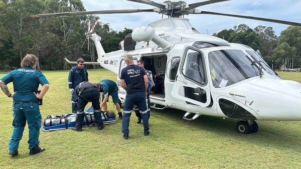 Team putting patient in helicopter
