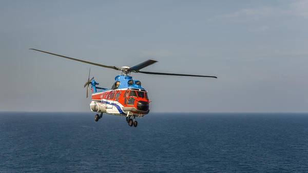 Helicopter flying over sea