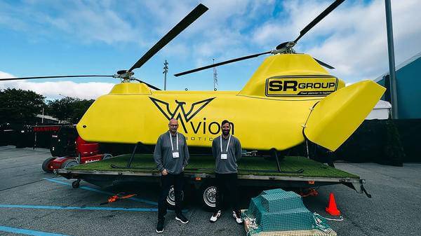 Workers standing next to avion robotic aircraft