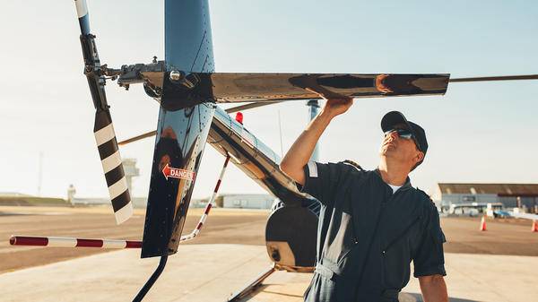 Pilot checking helicopter