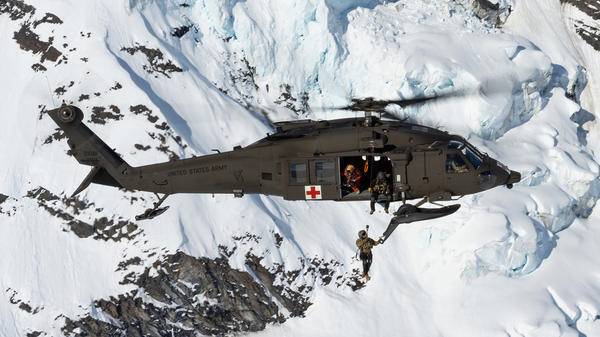Rescue helicopter in snowy mountain range