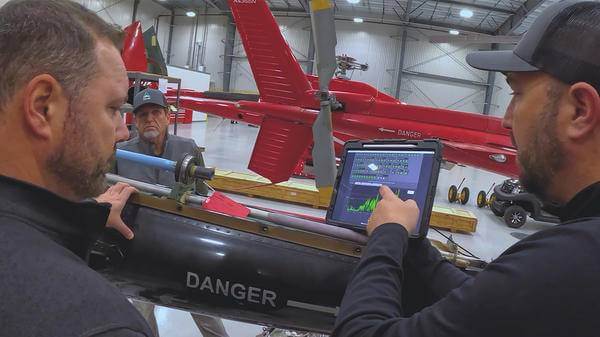 People talking thorough helicopter tech