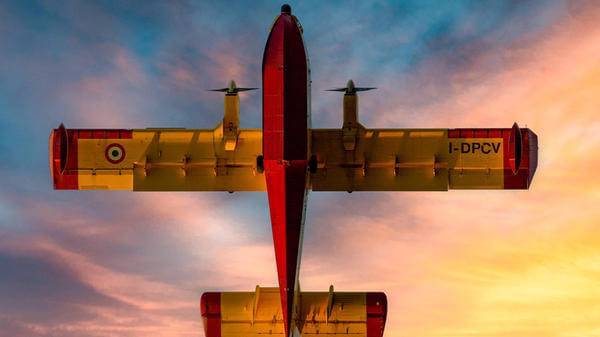 Shot of under plane with purple and pink sky behind