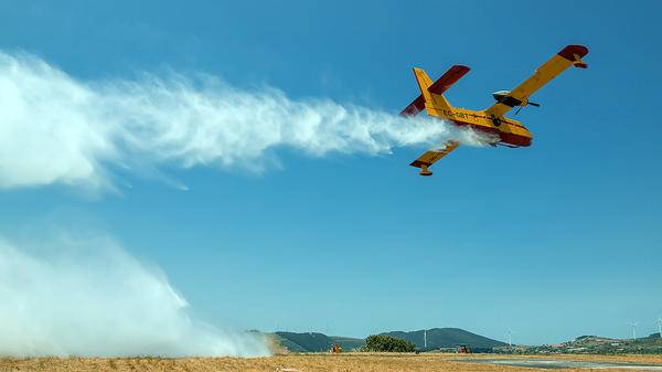 Yellow plane flying low to the ground