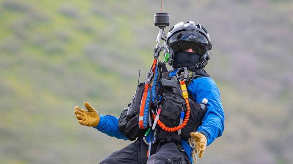 Man on hoisting out of helicopter
