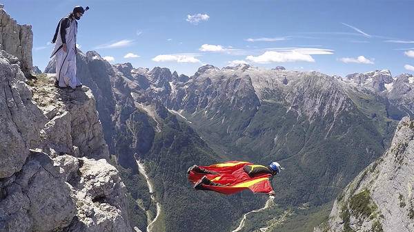Paraglider diving in mountains