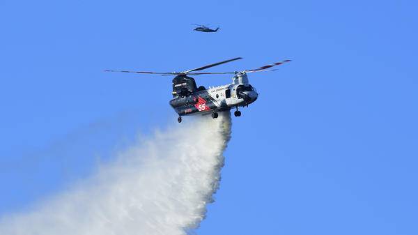 La county fire helicopter dropping fire retardant