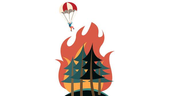 Firefighter diving into forest fire