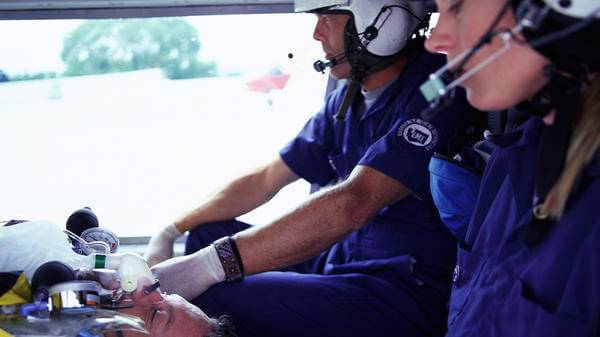 Paramedics treating patient on helicopter