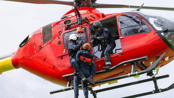 Rescue workers hoisting out of helicopter