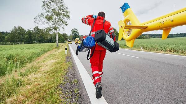 Paramedic walking towards helicopter