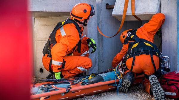 Paramedics fixing medical bench