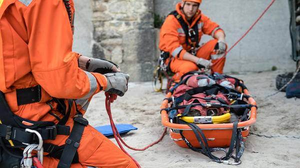 Paramedics fixing bench to ropes