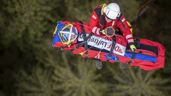 Paramedic hoisting up patient
