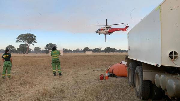 Helicopter flying over field