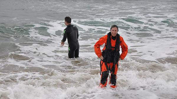 SAR workers standing in shallow sea water