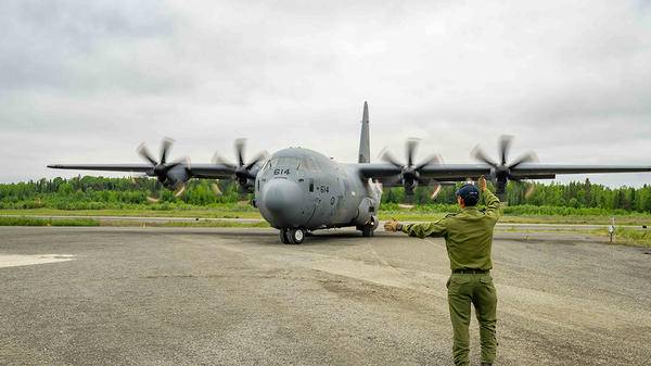 Man signalling plane to fly