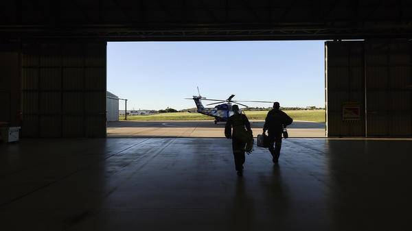 Helicopter pilots heading towards helicopter