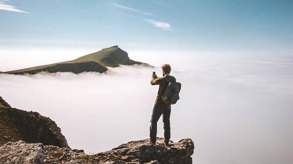 Guy on phone on mountain trying to get signal