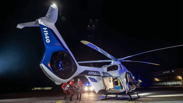 Airbus workers putting patient on helicopter