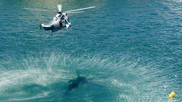Helicopter flying above water