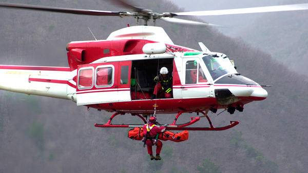 Paramedic being hoisted out of helicopter