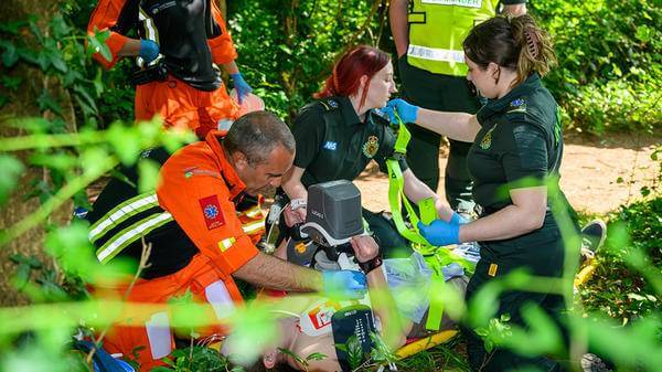 Paramedics attending man