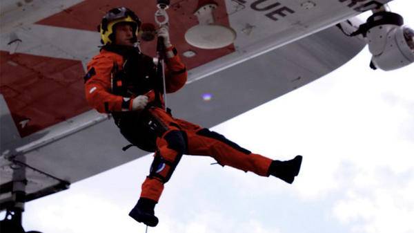 Paramedic being hoisted out of helicopter