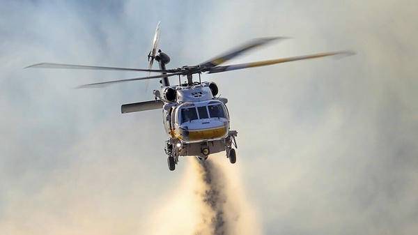 Helicopter dropping fire retardant