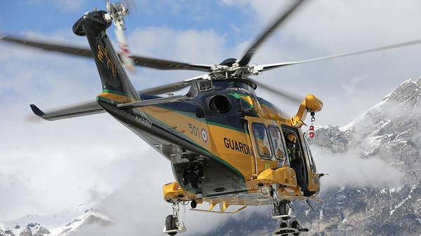 Yellow helicopter mid-flight