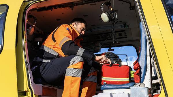 Paramedic looking though equipment