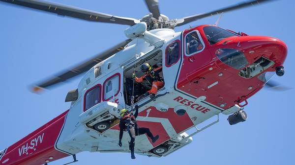 Rescue worker hoisted out of helicopter
