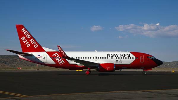 Red and white plane parked on runway
